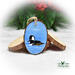 A hand-painted hooded merganser on water wood slice ornament available for purchase at Cove Creek Photography.